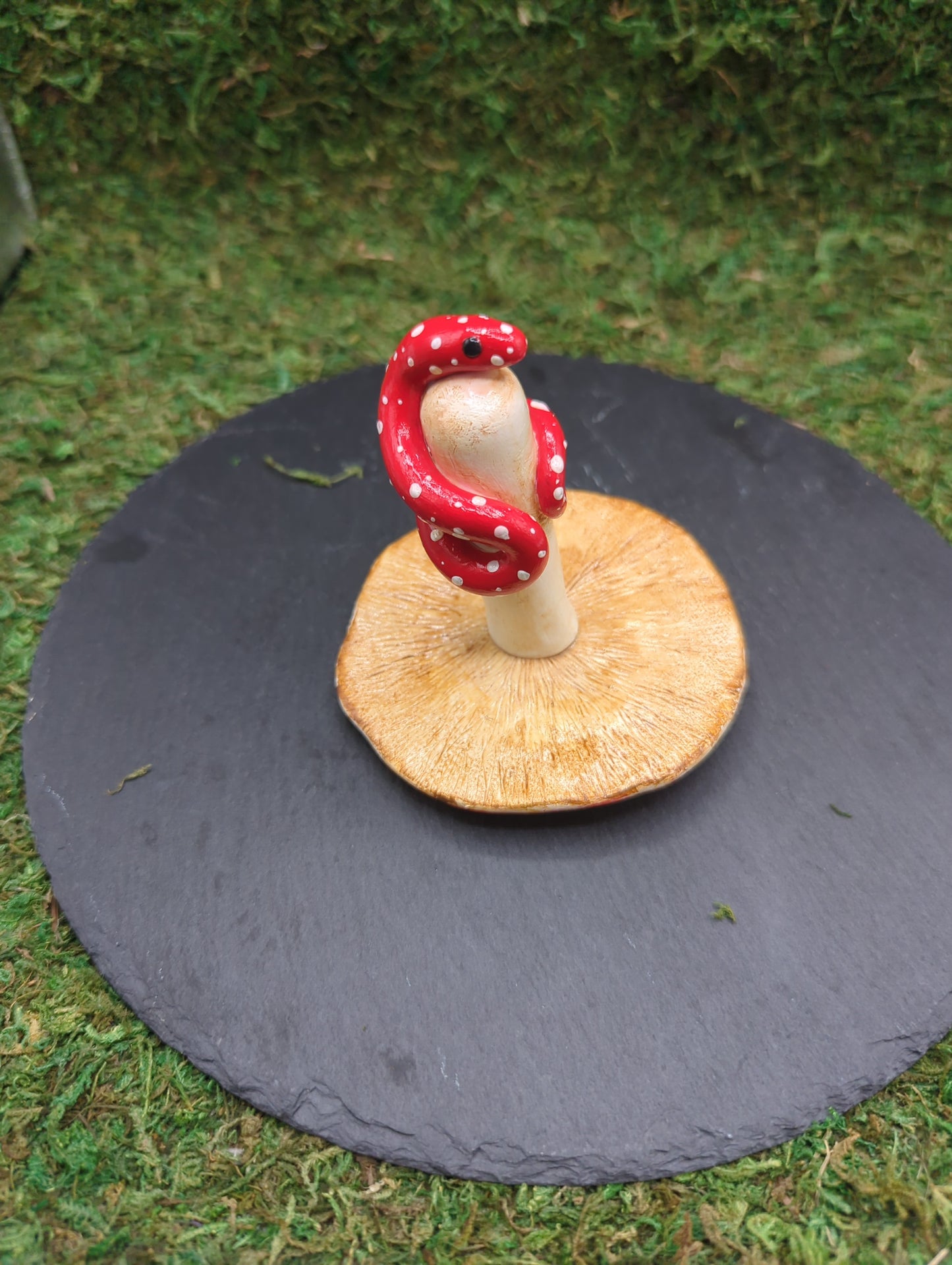 Snake with a mushroom sculpture