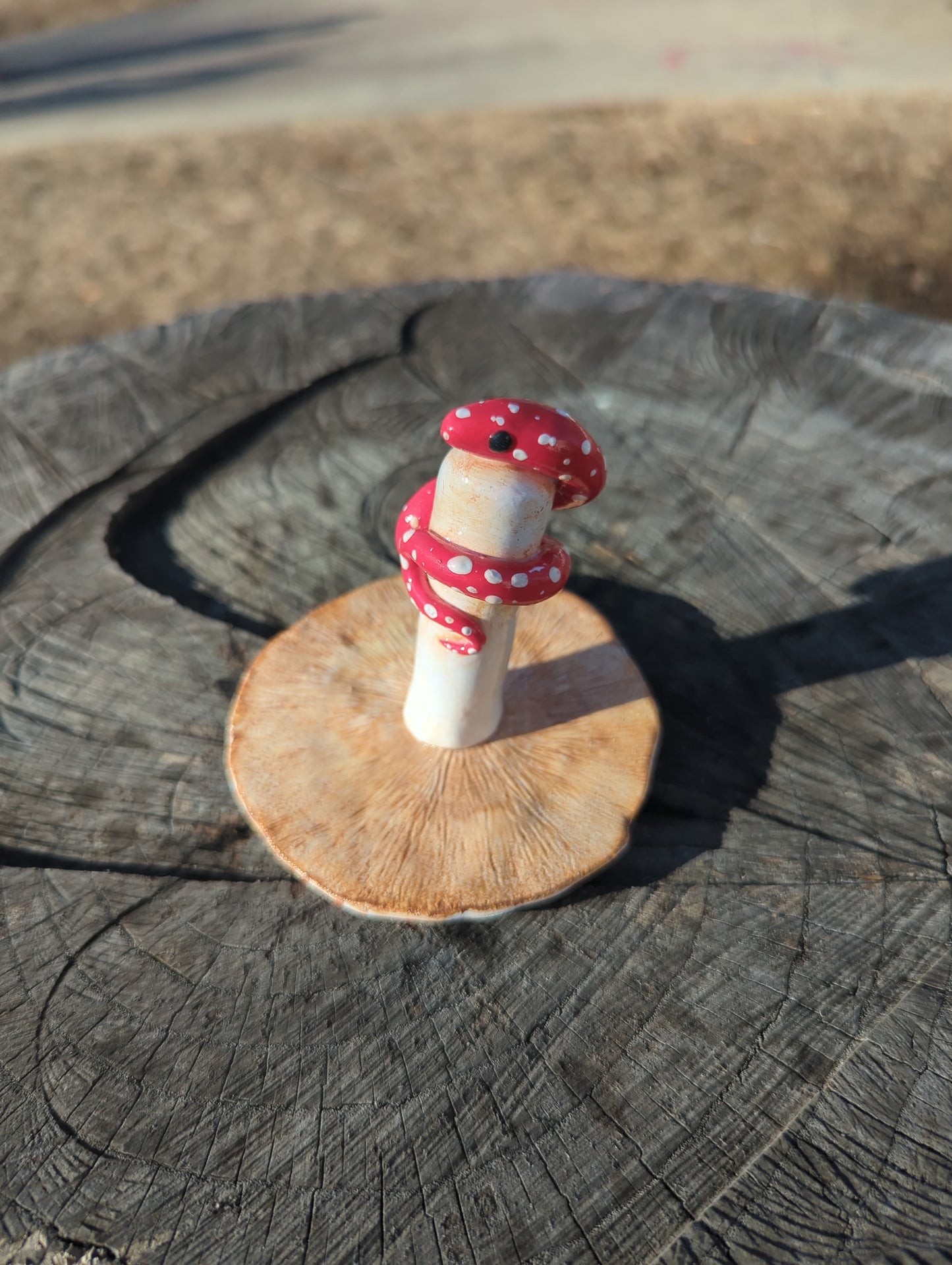 Snake with a mushroom sculpture