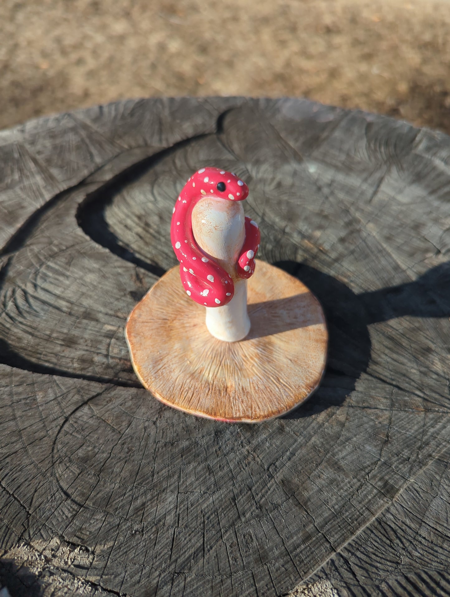 Snake with a mushroom sculpture