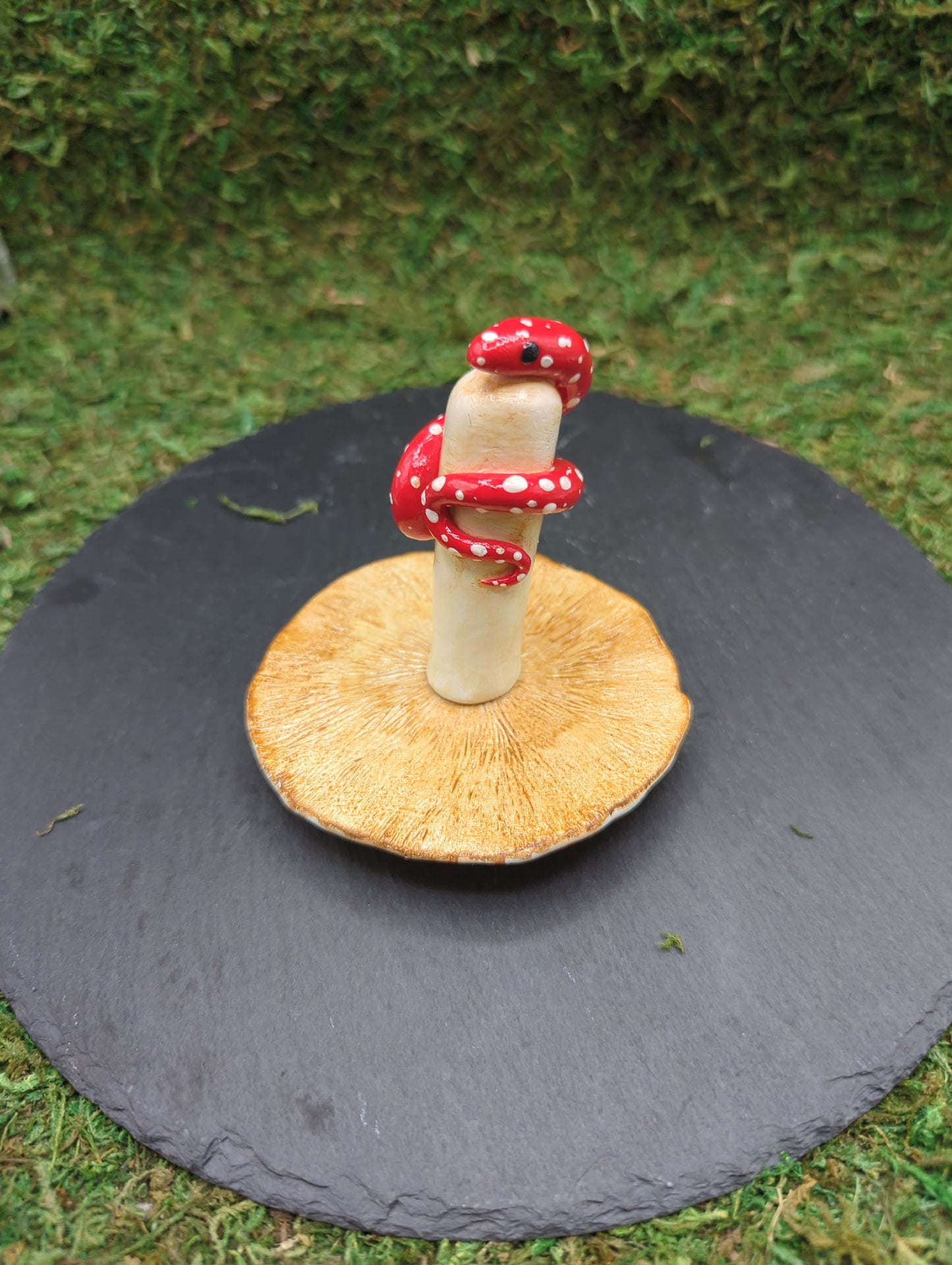 Snake with a mushroom sculpture